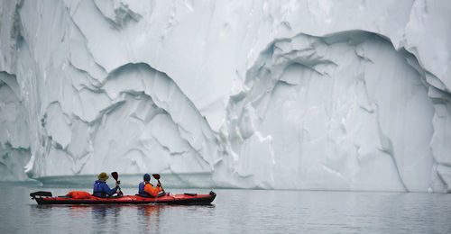 2 men traveling with a sea kayak in eastern greenland