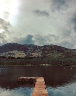 Pier over lake against sky