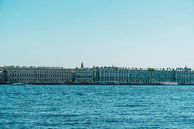 Sea with buildings in background