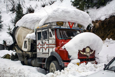 A snowbound cement truck parking on the road