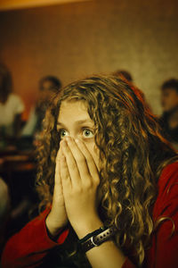 Portrait of woman covering face