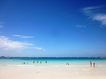 Scenic view of beach against blue sky