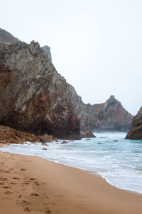 Scenic view of beach against clear sky