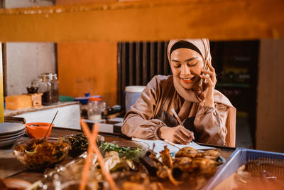 Young woman preparing food at home