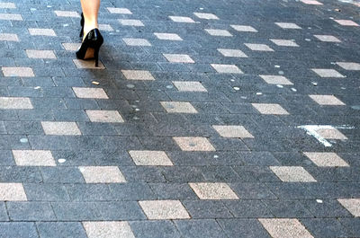 Low section of man on tiled floor