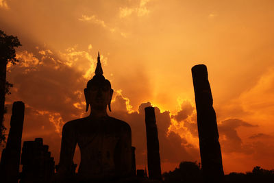 Silhouette statue against sky during sunset