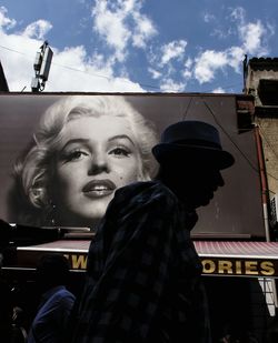 Low angle view of woman standing against sky