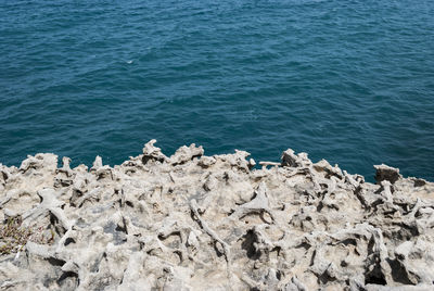 Scenic view of sea against rocks