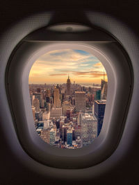 New york cityscape against sky seen through plane window