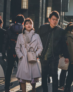 Friends standing in city during winter