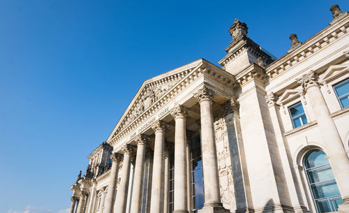 Low angle view of historical building against blue sky