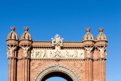 Low angle view of historical building against blue sky