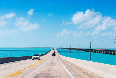 Road by sea against sky