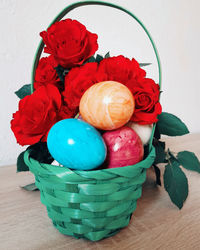 High angle view of red roses in basket on table