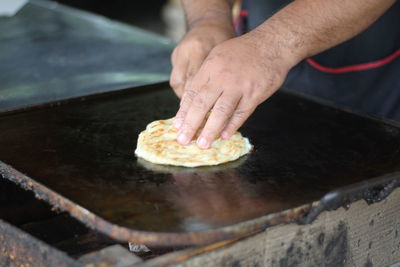 Midsection of person preparing food in kitchen