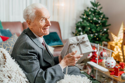 Side view of man holding gift