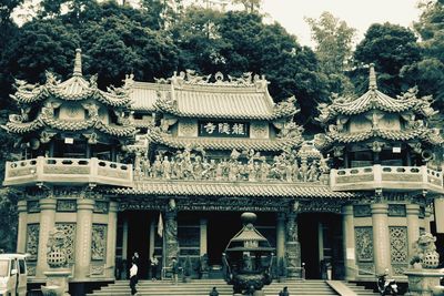 Group of people outside temple against building