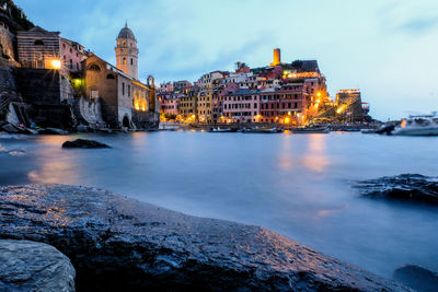 Illuminated city at waterfront