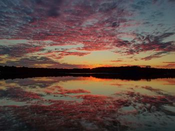 Scenic view of lake against romantic sky at sunset