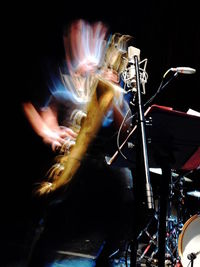 Young woman playing music in concert