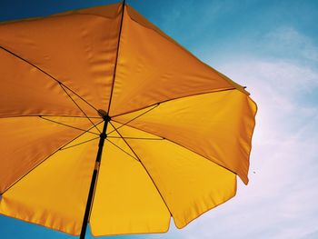 Low angle view of umbrella against sky