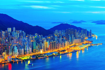 Illuminated city at waterfront