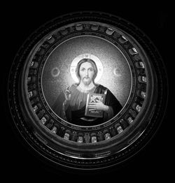 Portrait of man photographing against black background