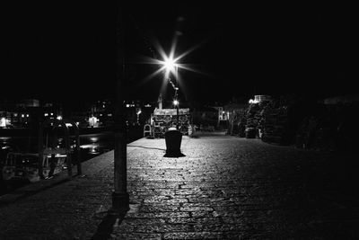 Man walking on illuminated street at night