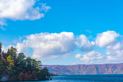 Scenic view of sea and mountains against sky