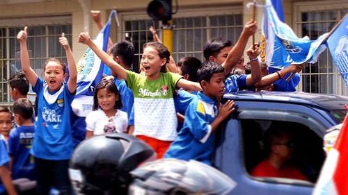 Friends playing with arms raised