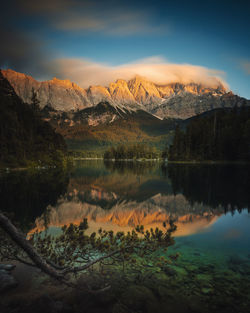 Scenic view of lake and mountains against sky