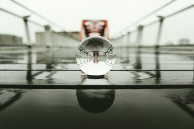 Close-up of crystal ball hanging on water