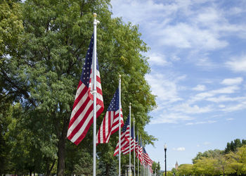 Low angle view of american flag against sky