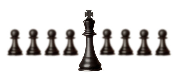 Close-up of chess pieces against white background