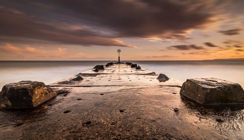 Scenic view of sea against cloudy sky