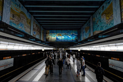 People at illuminated subway station