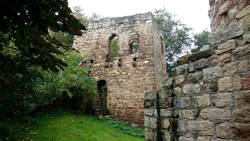 Low angle view of old ruins against sky