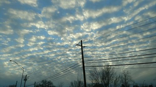 Low angle view of electricity pylon against sky