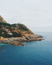 Scenic view of sea and mountains against sky