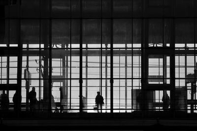 Rear view of silhouette man walking in modern building