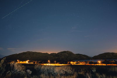 Scenic view of lake against sky at night