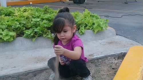Cute girl looking up while standing outdoors