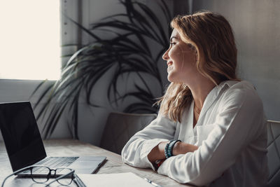 Young woman using laptop at office