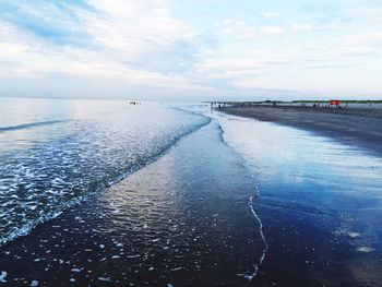 Scenic view of sea against cloudy sky