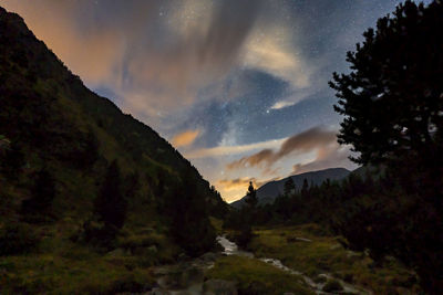 Scenic view of mountains against sky at night