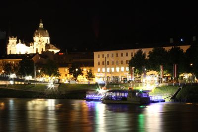 Boats in river with buildings in background