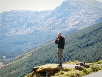 Rear view of man standing on mountain