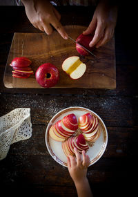 High angle view of woman preparing food on cutting board