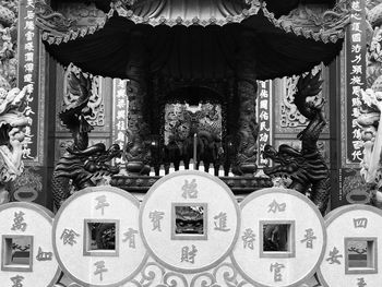 Close-up of cross against building