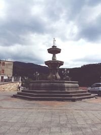 Statue of fountain in front of building